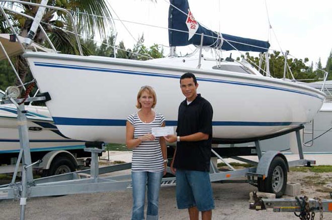 Jane Moon receives a sponsorship cheque on behalf of CISC from Jose Bush-Aleman at Harbour House Marina. © Byte Class http://bytechamps.org/